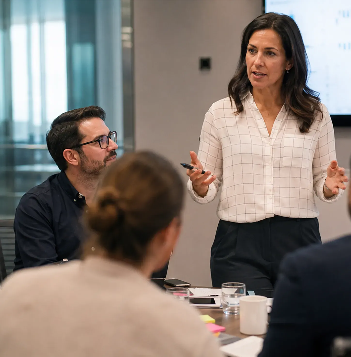 A business coach leading a working session with clients