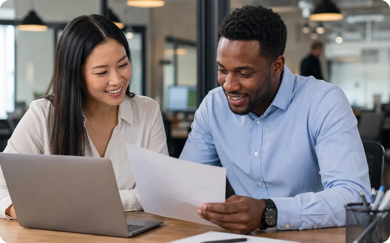 A recruiter and hiring manager reviewing a clear, conversion-focused recruiting website