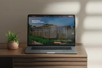 Laptop on a console table showing a custom home builder website